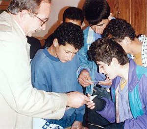 Bill Warnock, World Vision Jerusalem director, showing photos to Majid (centre) and other boys.